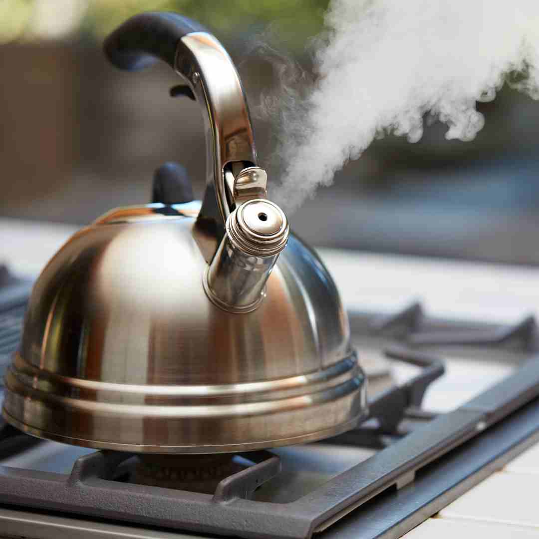 A kettle on stove with smoke rising from it - How to make tea in a kettle